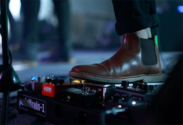 a foot placed on some effects pedals