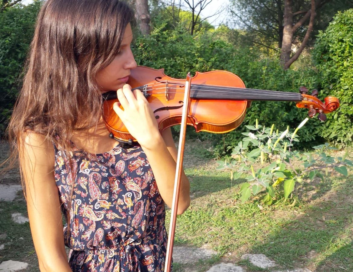 a violinist is tuning her violin