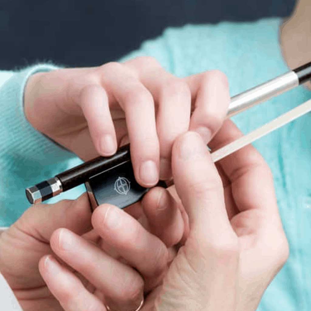 Child handling a violin bow